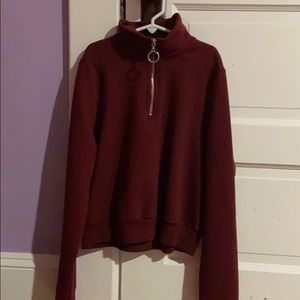 a long sleeve shirt with a circle zipper